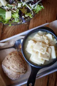 Chicken N Dumplings at Eckert's Restaurant with scone and side salad on platter.