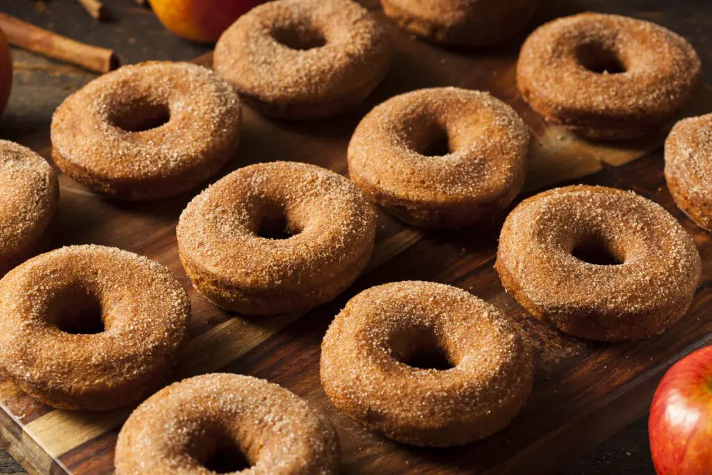 Freshly Made Cider Donuts laid out in rows.