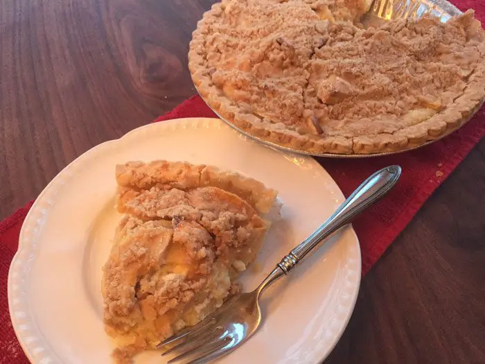 A picture of a slice of apples and cream crumb pie