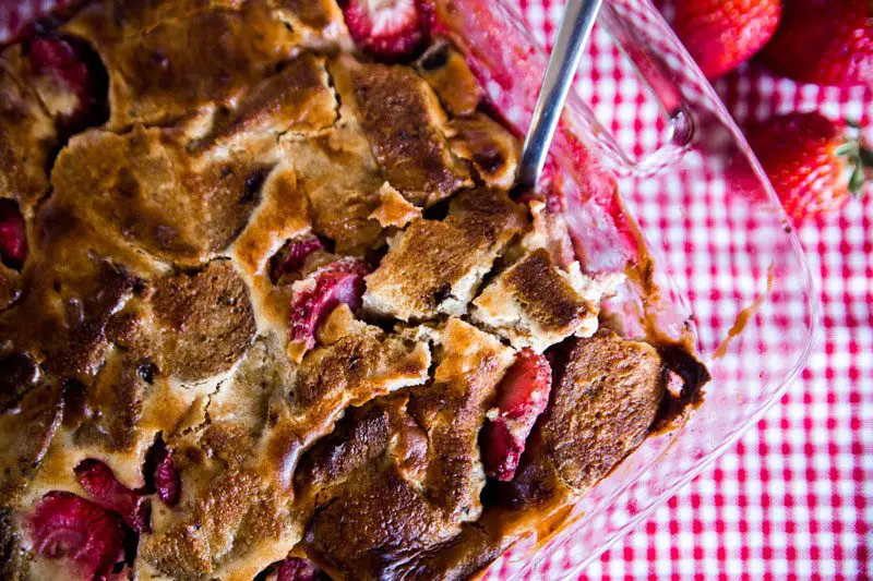 Overnight Strawberry Cream Cheese French Toast Casserole on gingham cloth.