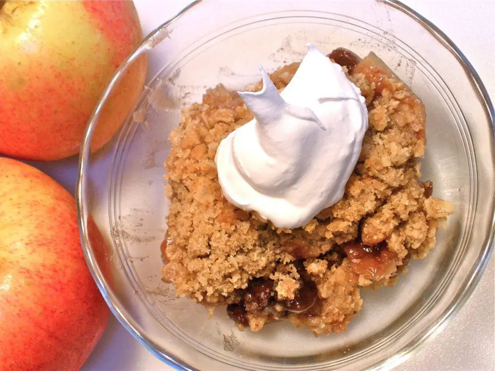 Apple Goodie with Oatmeal & Brown Sugar Topping in clear bowl with apples.