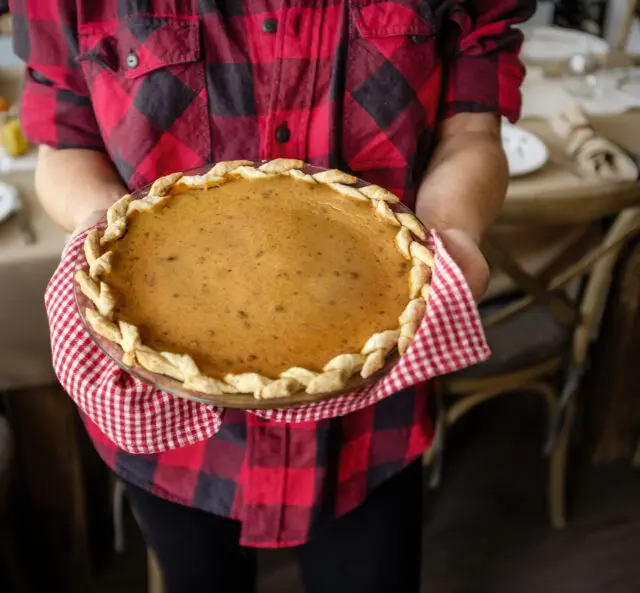 Person holding a fresh baked pie