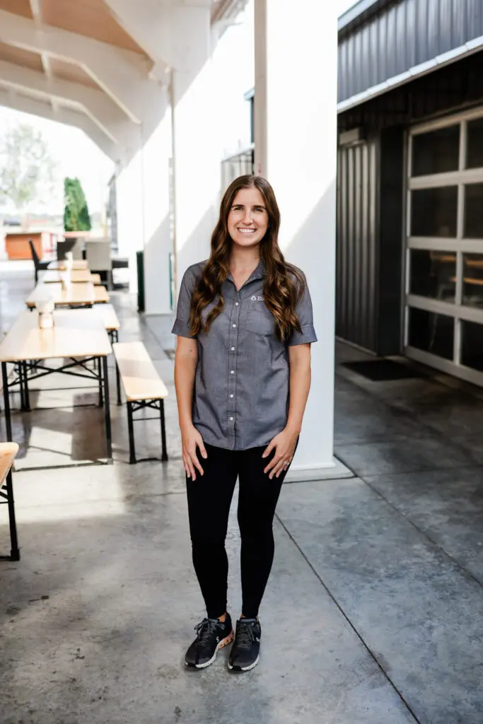 Belleville Country Store Manager, Katie Hayes, standing outside posing for picture