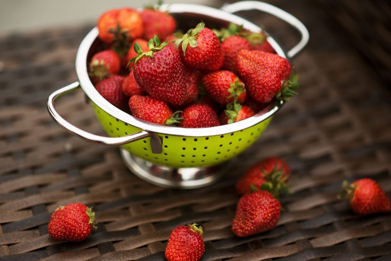A picture of strawberries in a colander