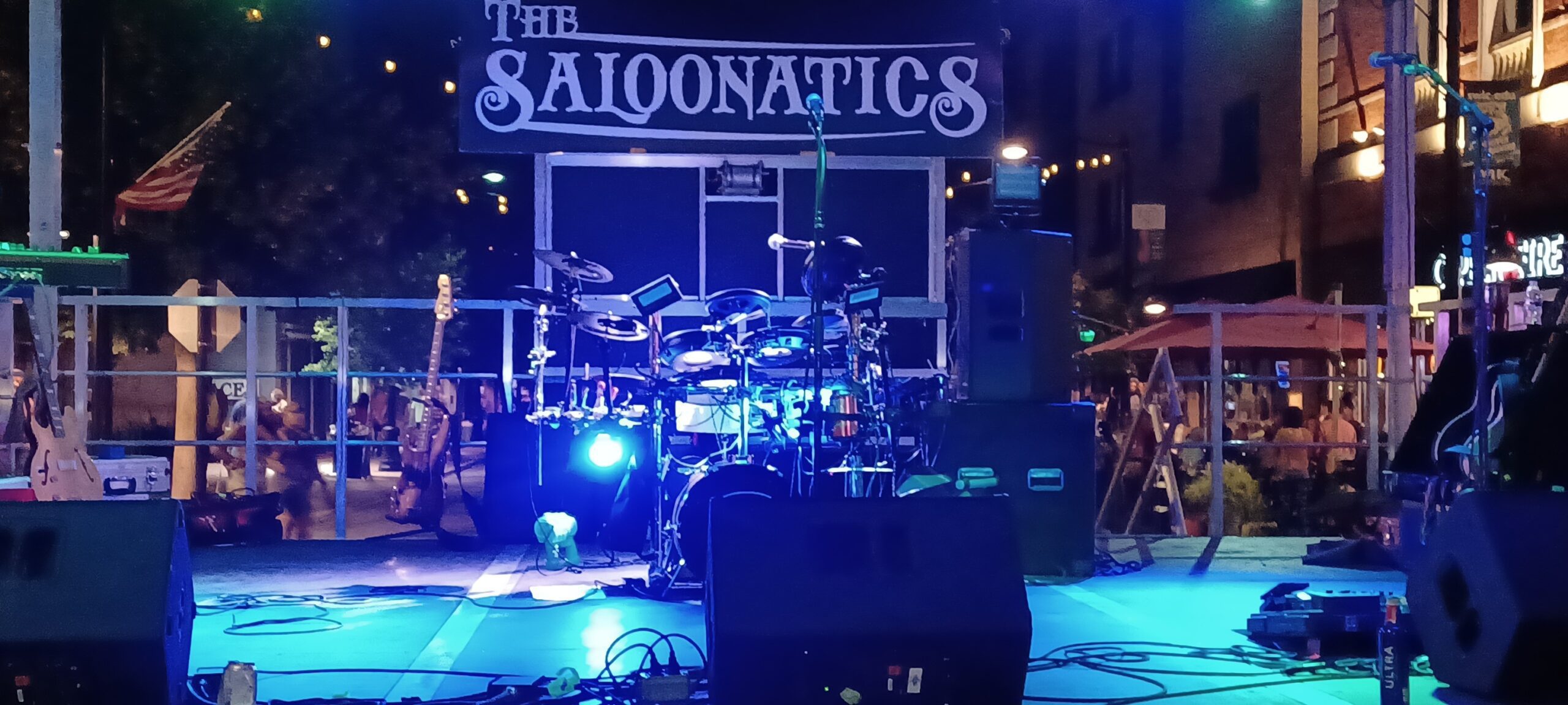 A nighttime outdoor stage setup with drums and 